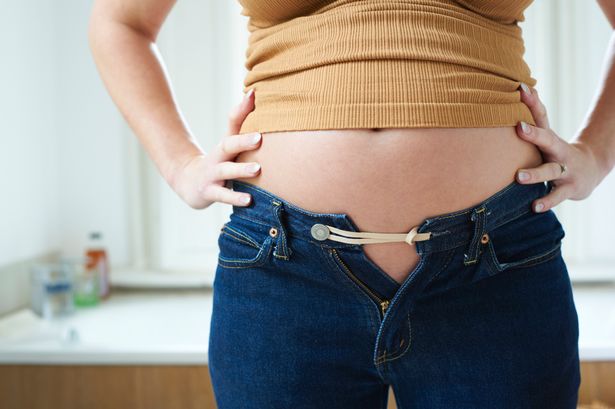 Pregnant-woman-bursting-out-of-jeans